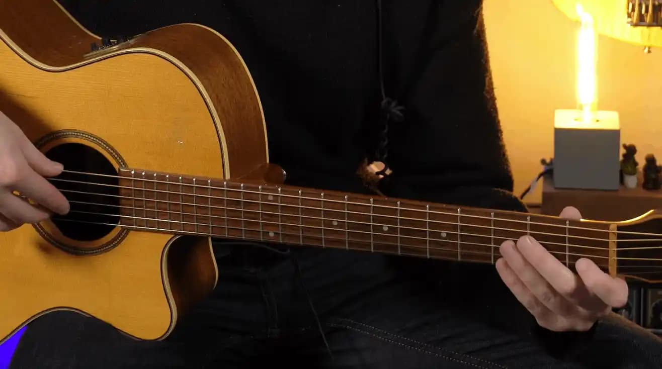 Kidstrument guitar course thumbnail showing the guitar body, neck and fretting hand