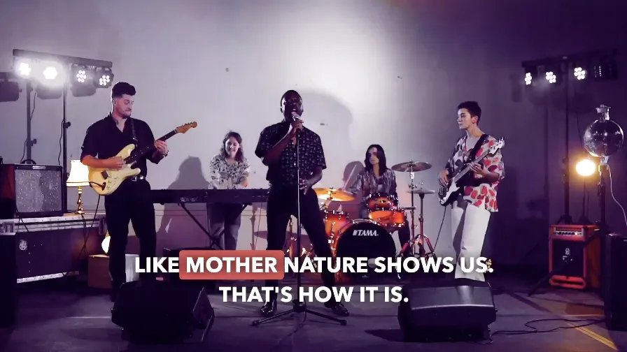 Children singing with vocal warm-ups and movement, reused to represent Lower KS2 singing and performance